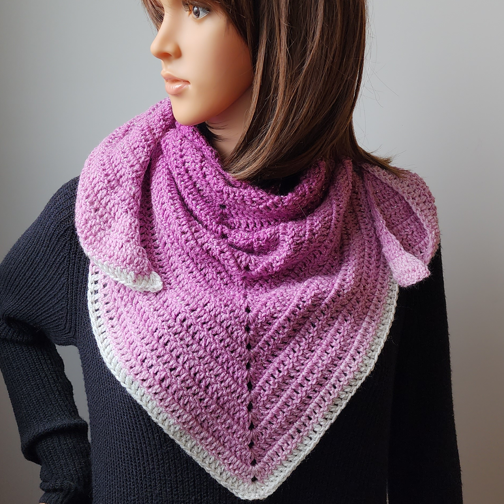 Make this lightweight triangle scarf with just 1 cake of Red Heart Roll With It Sparkle yarn! This free crochet pattern uses beginner stitches and adds the perfect hint of shimmer. #crochetscarf #trianglewrap #freecrochetpattern #sparkleyarn #redheartyarn #crochetaccessories