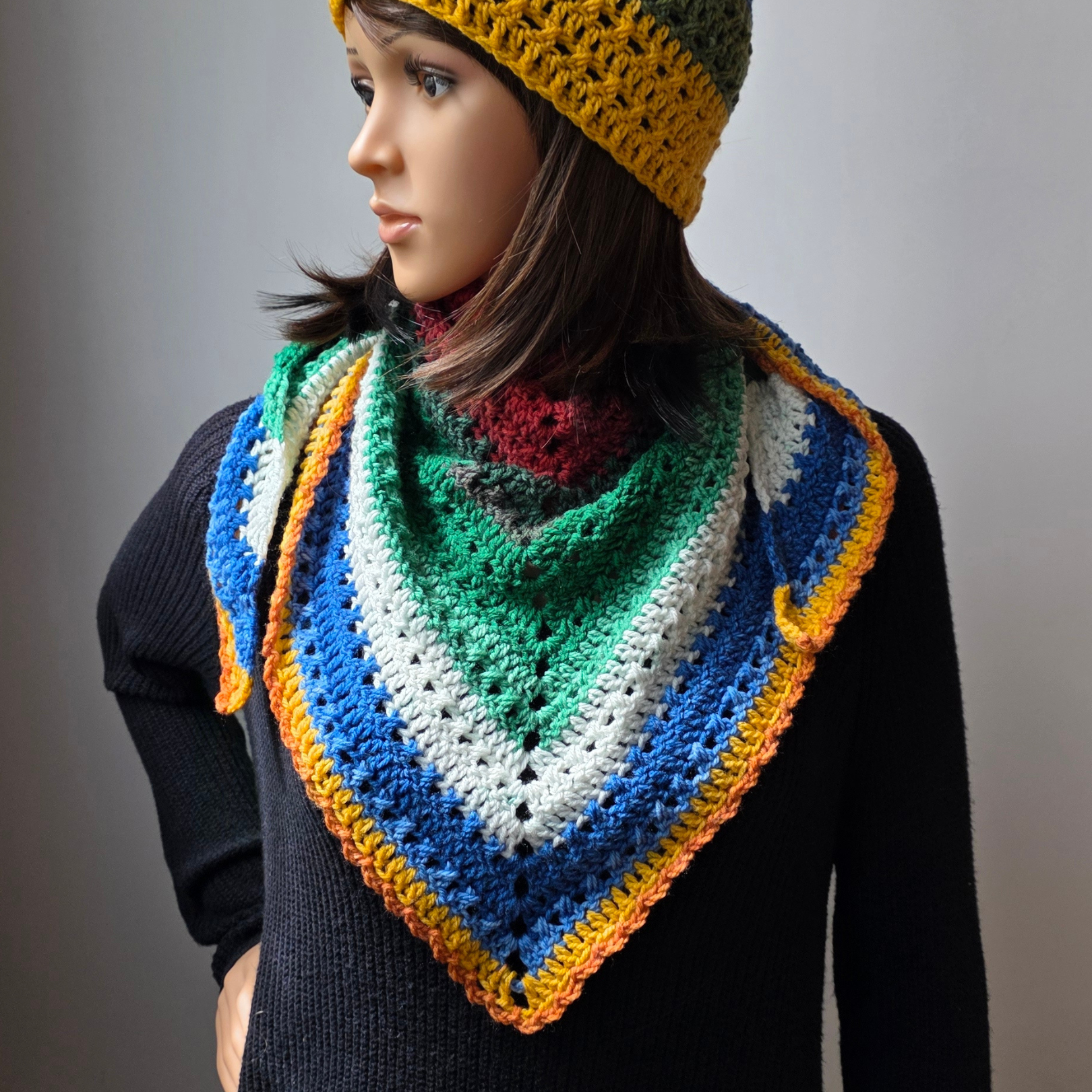 Top-down design in jewel tones with crossed double crochet stitches. Easy to customize for your perfect scarf!